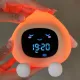 Lumulu sömntränare i orange silikon med sovande ansikte och digital tidsvisning på displayen